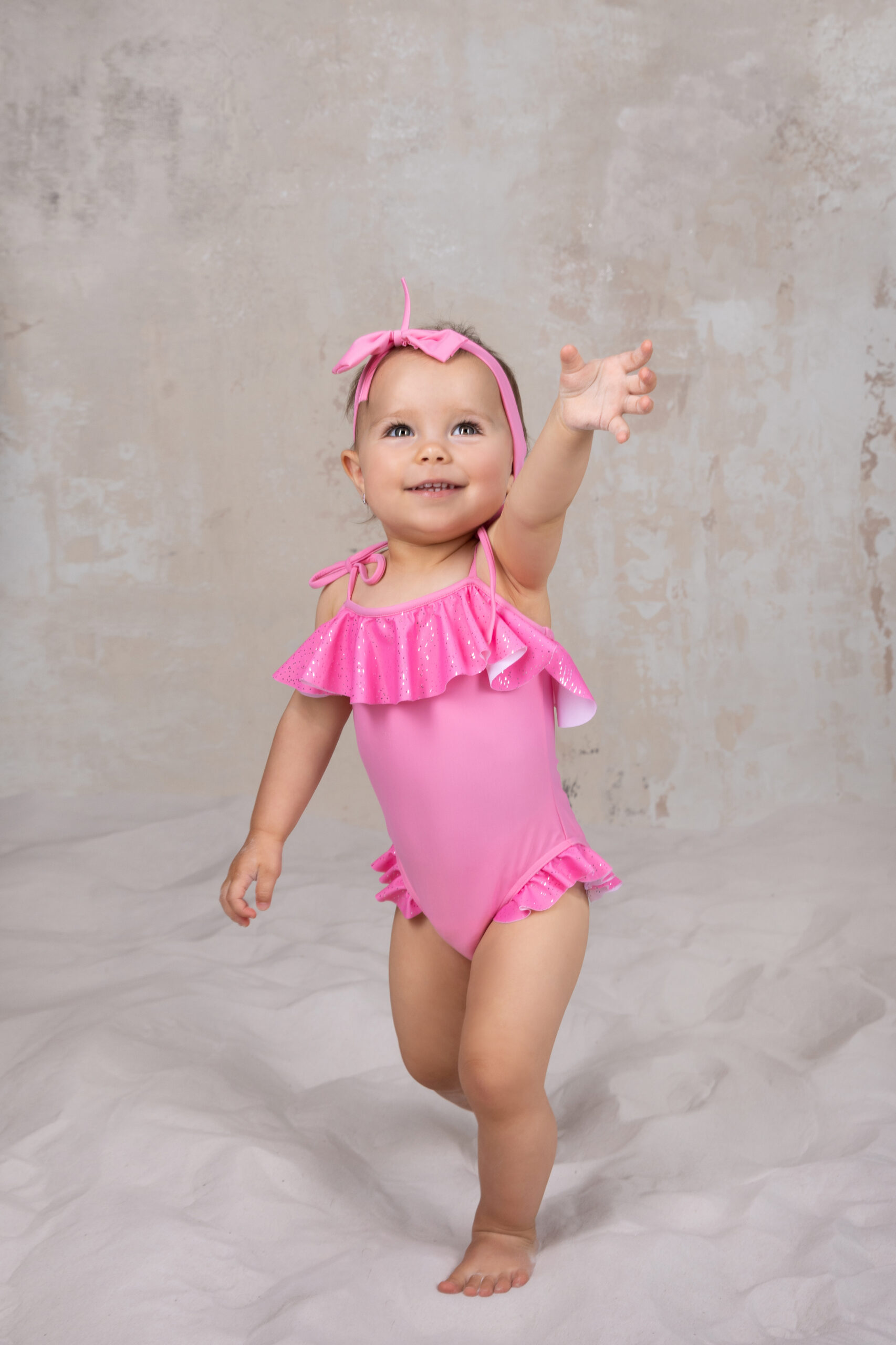 Pink baby swimsuit with headband